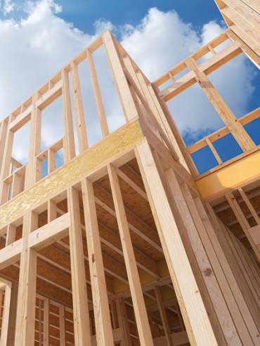 Assembling a frame house on the construction site. 3d illustration